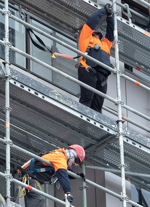 2 construction workers working on scaffolding
