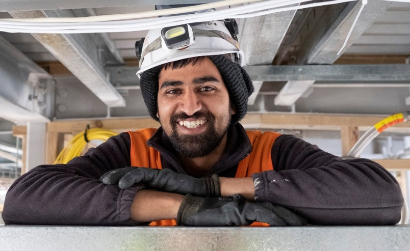 Indian construction worker smiling at camera