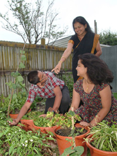 Ganan and family working in the vegetable garden